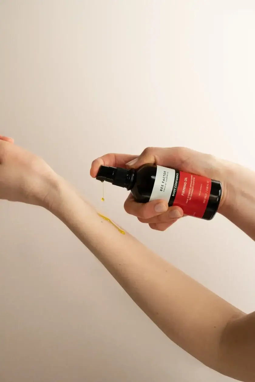 Γυναίκα εφαρμόζει το Bee Factor Body Confidence Firming Oil στον καρπό του χεριού της – φυσικό λάδι σύσφιξης με θαλάσσιο πλαγκτόν, ιδανικό για τοπικό πάχος, ελαστικότητα και λείανση, διαθέσιμο στο eiria.gr.