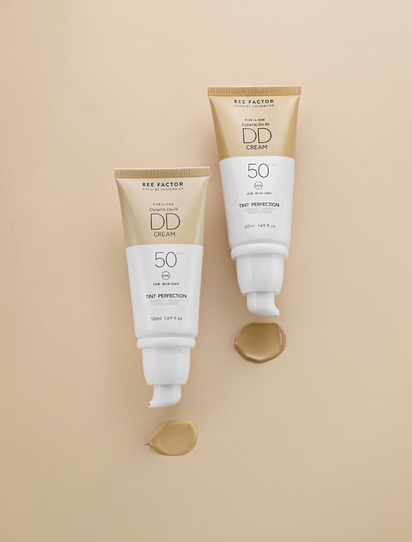 Δύο σωληνάρια από την 5 in 1 DD Κρέμα Προσώπου SPF50 Bee Factor, Shade 01 και Shade 02, με δείκτη προστασίας UVB, UVA και μπλε ακτινοβολίας. Διαθέσιμα στο Eiria Cosmetics για άψογη κάλυψη και προστασία.