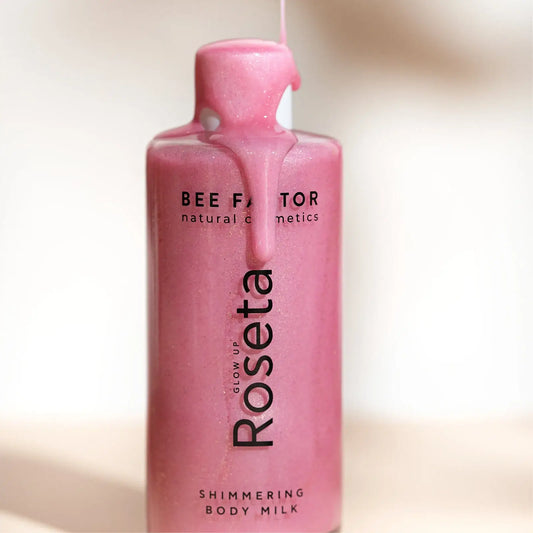 Glow Up Roseta Shimmering Body Milk 100ml της Bee Factor, το προϊόν χύνεται στη συσκευασία.